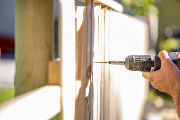 A professional installing fences